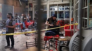 Syrian security inspects the site after an explosive device was detonated in a cafe near the main courthouse complex in Damascus, 2 July, 2026