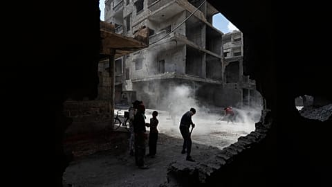 Residents remove rubble from damaged buildings in the al-Hajar al-Aswad neighbourhood on the outskirts of Damascus, 29 April, 2026