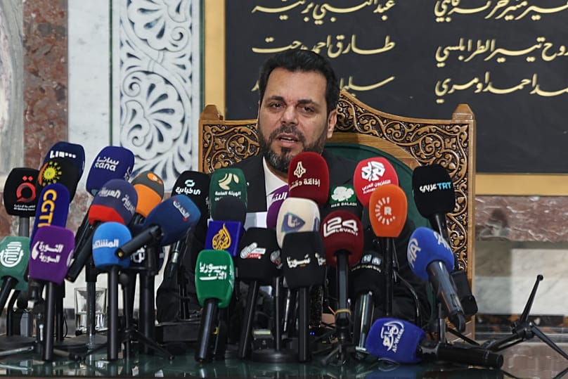 The head of Syria's electoral committee, Mohammed Taha al-Ahmad, speaks during a press conference in Damascus, 1 July, 2026