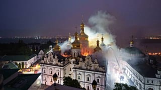 Rescue workers try to put out a fire at the Dormition Cathedral of thousand-year-old Monastery of Caves, also known as Kyiv Pechersk Lavra, following a Russian strike on Kyiv,