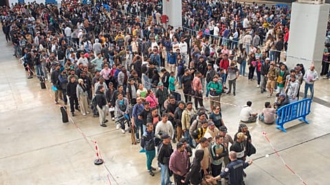 Migrants queue at a public service office to obtain paperwork needed to apply for Spain's immigration amnesty near Barcelona, 21 April, 2026