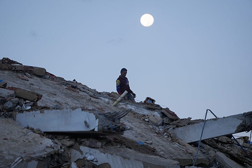 A man walks amid the rubble of a building that collapsed in the earthquakes in La Guaira, 1 July, 2026