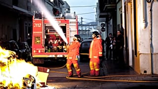 Two firefighters put out a fire in Valencia
