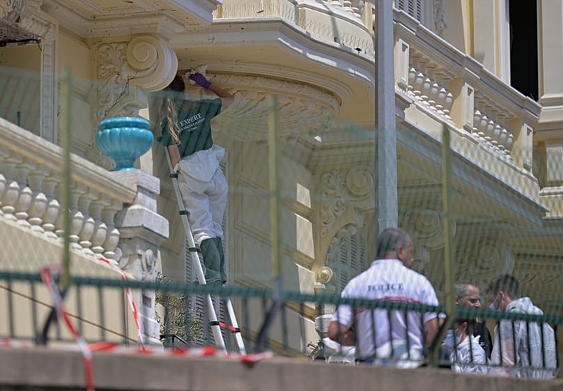An investigator examines the scene at the residential building where an explosive device seriously injured three people in Monaco, 30 June, 2026