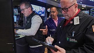 Specialist Glenn Carell and Dilip Patel work with trader Jeffrey Vazquez on the floor of the New York Stock Exchange, 26 June 2026