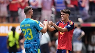 Spain goalkeeper Unai Simon (23) celebrates with Pau Cubarsi (22) after the World Cup round of 32 soccer match between Spain and Austria in Inglewood, California.