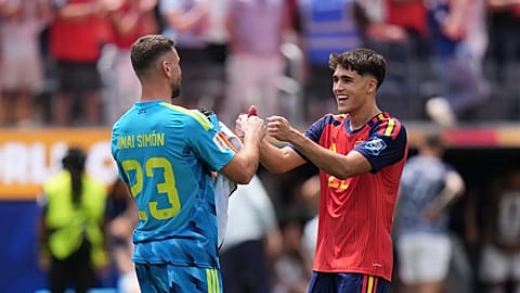 Spain goalkeeper Unai Simon (23) celebrates with Pau Cubarsi (22) after the World Cup round of 32 soccer match between Spain and Austria in Inglewood, California.