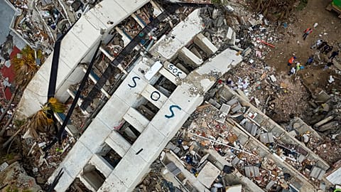 SOS is seen on collapsed buildings following the twin earthquakes in Caraballeda in the state of La Guaira, 2 July, 2026