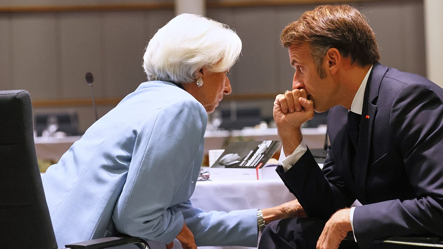 European Central Bank President Christine Lagarde, left, speaks with French President Emmanuel Macron during a Euro Summit working dinner in Brussels, October 2025.