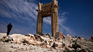 Two men stand on the ruins of the Temple of Bal, which was destroyed by ISIS in 2015, at the ancient city of Palmyra, Syria, Saturday, Jan. 25, 2025. (AP Photo/Khalil Hamra)
