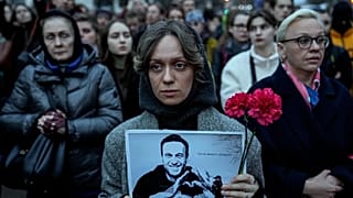 A woman holds a portrait of Russian opposition leader Alexei Navalny during a protest in front of the Russian embassy in Berlin, 2024. 
