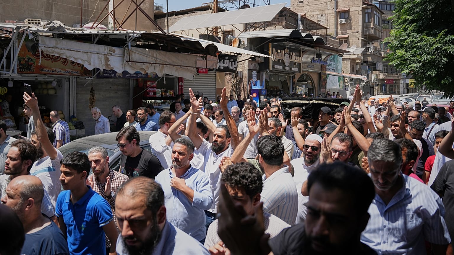Mourners carry the coffin of one of the victims of an explosive device detonated in a cafe near Damascus' main courthouse, 3 July, 2026