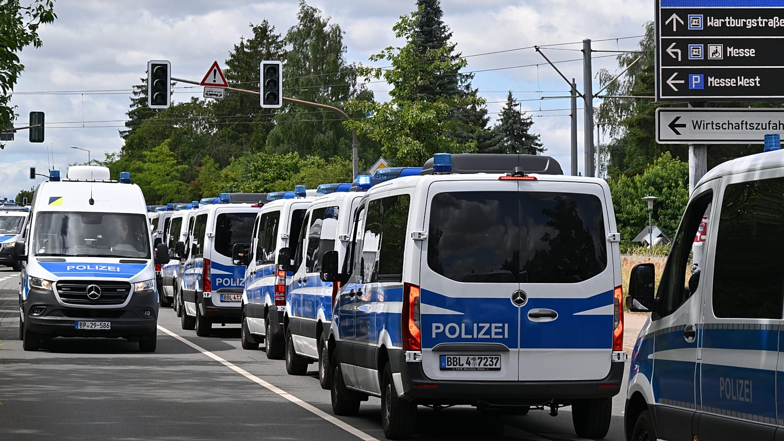 Police vehicles stationed outside the Erfurt Exhibition Center, Erfurt, Germany, Friday July 3, 2026, ahead of the AfD national party convention on July 4 and 5.