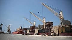 In this Saturday, Sept. 29, 2018 photo, a cargo ship and oil tanker ship are idle at the port of al-Hudaydah, Yemen.
