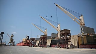 In this Saturday, Sept. 29, 2018 photo, a cargo ship and oil tanker ship are idle at the port of al-Hudaydah, Yemen.