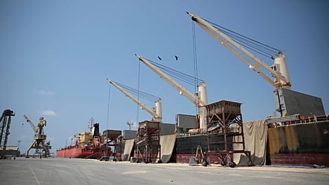 In this Saturday, Sept. 29, 2018 photo, a cargo ship and oil tanker ship are idle at the port of al-Hudaydah, Yemen.
