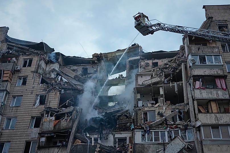 Rescuers work the scene of a building damaged by Russian missile attack in Kyiv, Ukraine, Monday, July 6, 2026. 