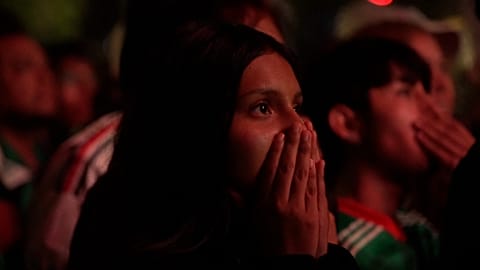 Mexico City, Mexico, 05 June 2026: A female supporter covers her face as she watches Mexico lose to England at the 2026 World Cup.