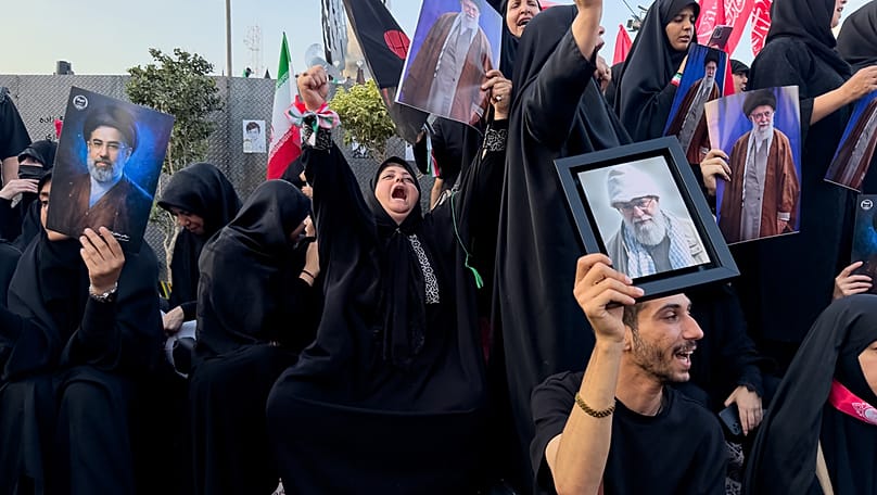 Mourners hold a portrait of Iran's new Supreme Leader, Mojtaba Khamenei and portraits of the slain Iranian Supreme Leader Ayatollah Ali Khamenei, Tehran, July 6, 2026 