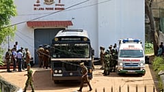 Security personnel stand guard in the compound of a prison where deadly clashes broke out in Negombo, 6 July, 2026