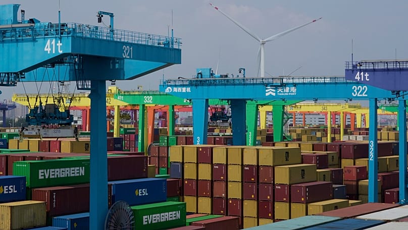 Shipping containers are stacked at a port in Tianjin, China, Friday, Aug. 29, 2025. (AP Photo/Mahesh Kumar A., file)