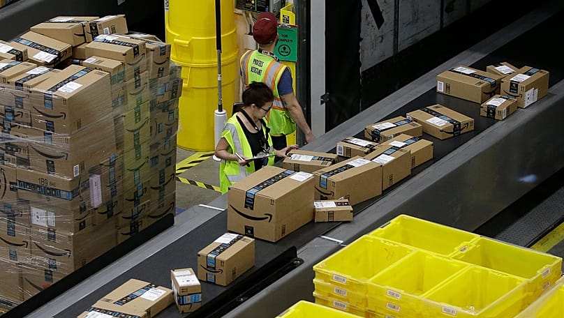 packages move down a conveyor system to the proper shipping area at the Amazon Fulfillment Centre. (AP Photo/Rich Pedroncelli, File)enter. 
