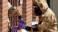 Specialist team members in military protective suits during Novichok nerve agent clean-up operations in Salisbury, 6 July, 2018