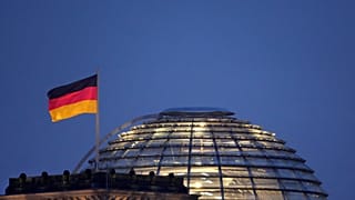 A German flag waves on top of the Reichstag building, home of the German federal parliament, Bundestag, in Berlin, Germany, Thursday, Nov. 18, 2021. 