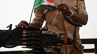 FILE - A Sudanese soldier from the Rapid Support Forces or RSF stands on his vehicle in the East Nile province, Sudan, on June 22, 2019