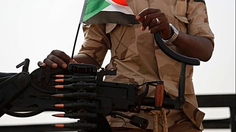 FILE - A Sudanese soldier from the Rapid Support Forces or RSF stands on his vehicle in the East Nile province, Sudan, on June 22, 2019