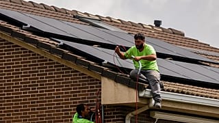 Workers install solar planers on the roof of a house in Rivas Vaciamadrid, Spain.