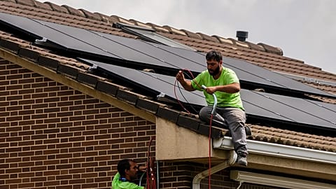 Workers install solar planers on the roof of a house in Rivas Vaciamadrid, Spain.