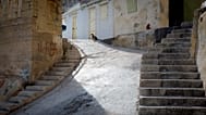 Two cats sit at the top of the stairway in the middle of a small fisherman's landing in Valletta, Malta, on Thursday, Feb. 2, 2017.