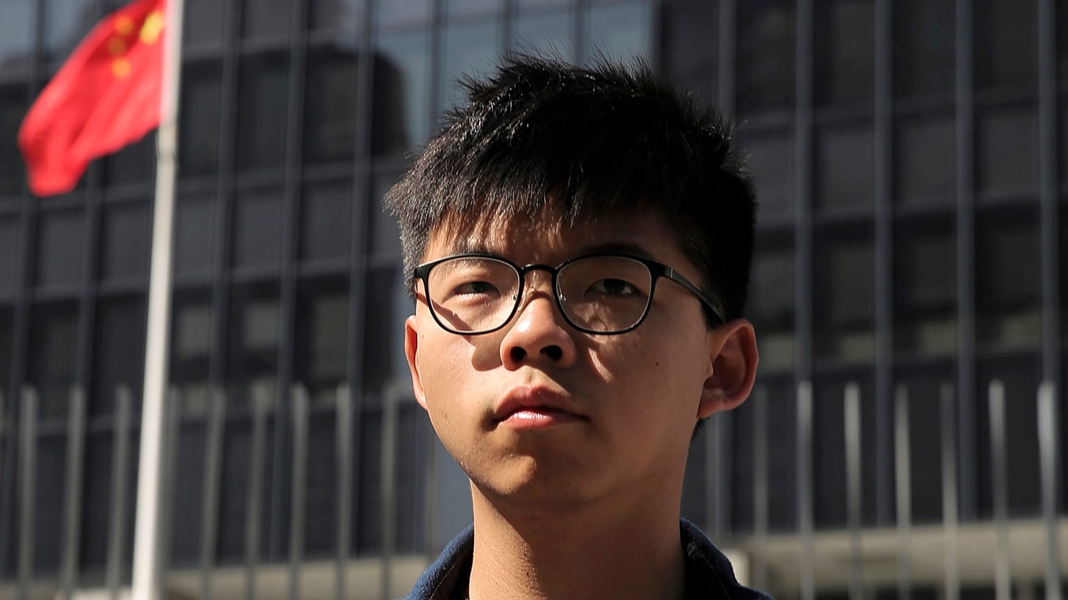 Pro-democracy activist Joshua Wong stands outside the Legislative Council building in Hong Kong, 28 November, 2019