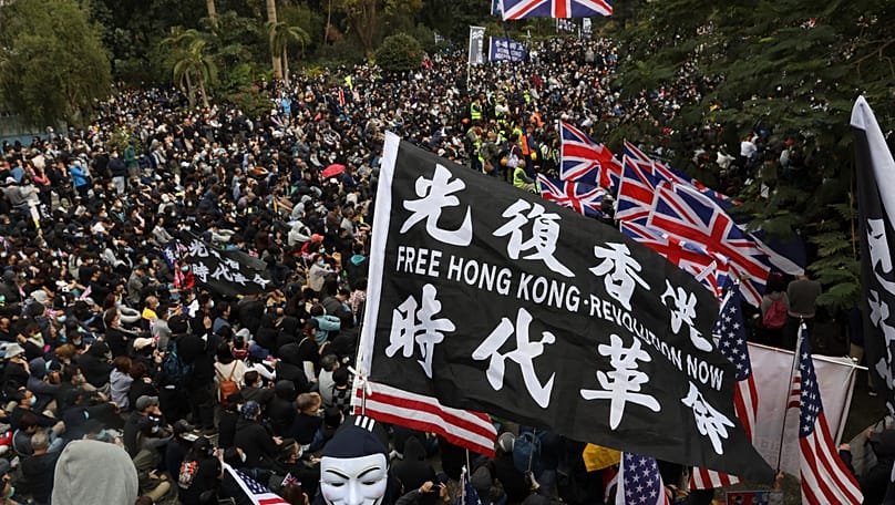Participants wave British and US flags during a rally demanding electoral democracy and call for boycott of the Chinese Communist Party in Hong Kong, 19 January, 2020