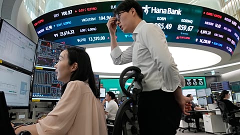 Currency traders watch monitors at the foreign exchange dealing room of the Hana Bank headquarters in Seoul, South Korea, 7 July 2026
