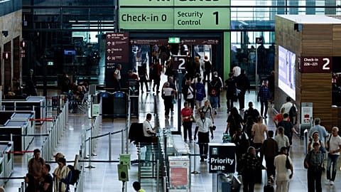Passengers in a terminal at Berlin's Brandenburg airport, in Schönefeld, Germany, Saturday Sept. 20, 2025, after a cyberattack targeting check-in and boarding systems disrupte