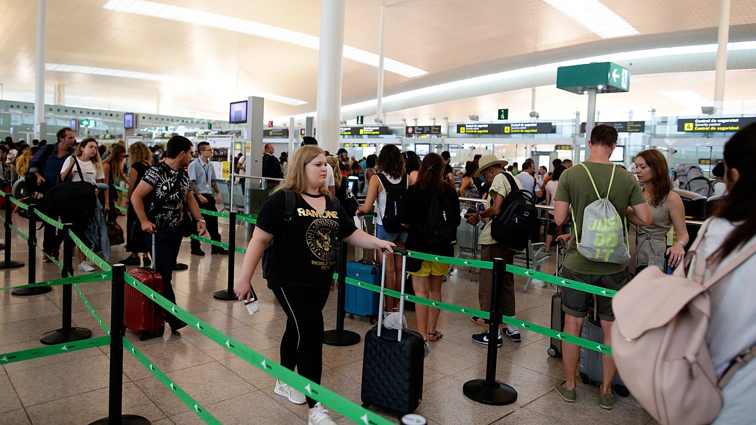 Passenger wait for pass the security control at the Barcelona airport in Prat Llobregat, Spain, Tuesday, Aug. 1, 2017. Passenger are facing hours of extra-long security queues