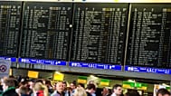 Passengers stand in the terminal of the airport in Frankfurt Main, Germany, Tuesday March 12, 2013.
