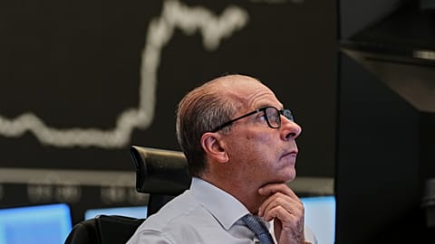 A broker watches his screens at the stock market in Frankfurt, Germany, Friday, April 17, 2026.