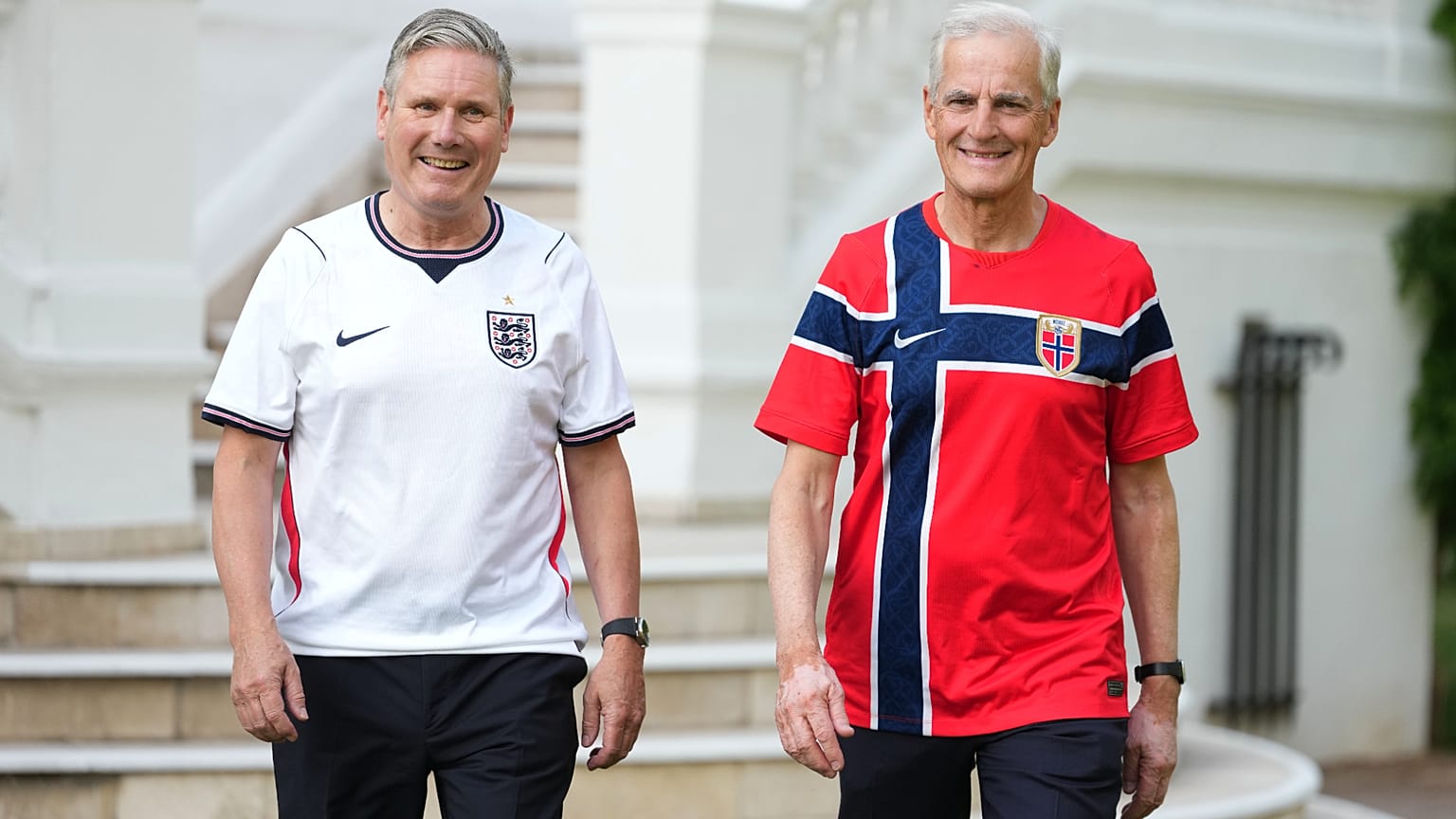 Britain's Prime Minister Keir Starmer, left, and Norway's Prime Minister Jonas Gahr Store wear team soccer jerseys as they walk prior to a meeting at the British Embassy