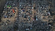 Relatives and rescue teams search through the rubble of buildings collapsed during the earthquakes in La Guaira, 7 July, 2026