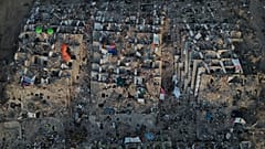 Relatives and rescue teams search through the rubble of buildings collapsed during the earthquakes in La Guaira, 7 July, 2026