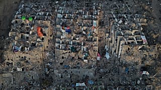 Relatives and rescue teams search through the rubble of buildings collapsed during the earthquakes in La Guaira, 7 July, 2026
