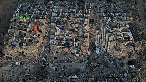 Relatives and rescue teams search through the rubble of buildings collapsed during the earthquakes in La Guaira, 7 July, 2026