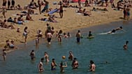 Swimmers cool off on a beach in Barcelona, 27 May, 2026