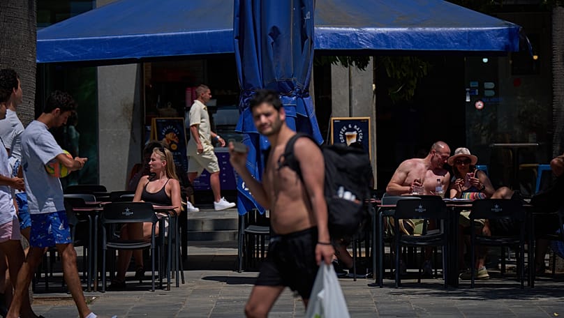 Customers sunbathing whilst having a drink on a terrace in Barcelona, 27 May, 2026