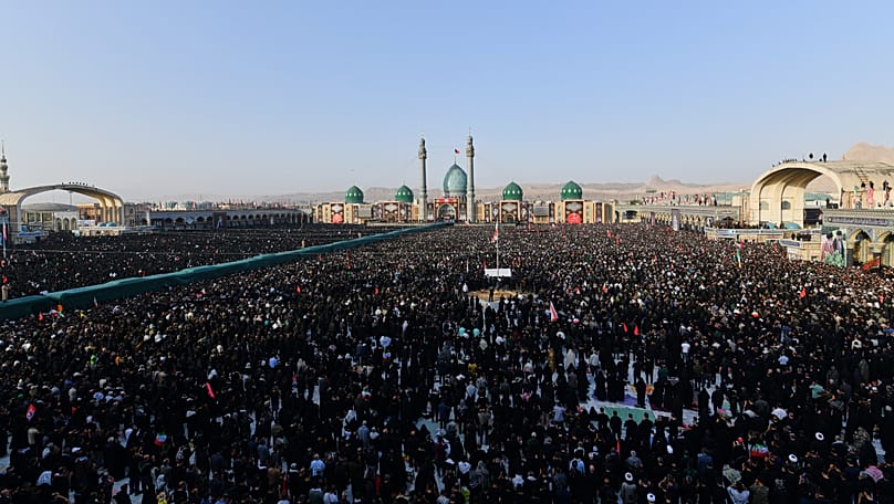 Thousands gather for funeral prayers for the late Iranian Supreme Leader Ayatollah Ali Khamenei and members of his family at the Holy Jamkaran Mosque in Qom, Iran, Tuesday.