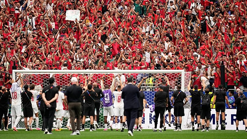 Morocco's players celebrate with fans after their 3-0 win in the World Cup round of 16 match against Canada in Houston, Saturday, July 4, 2026