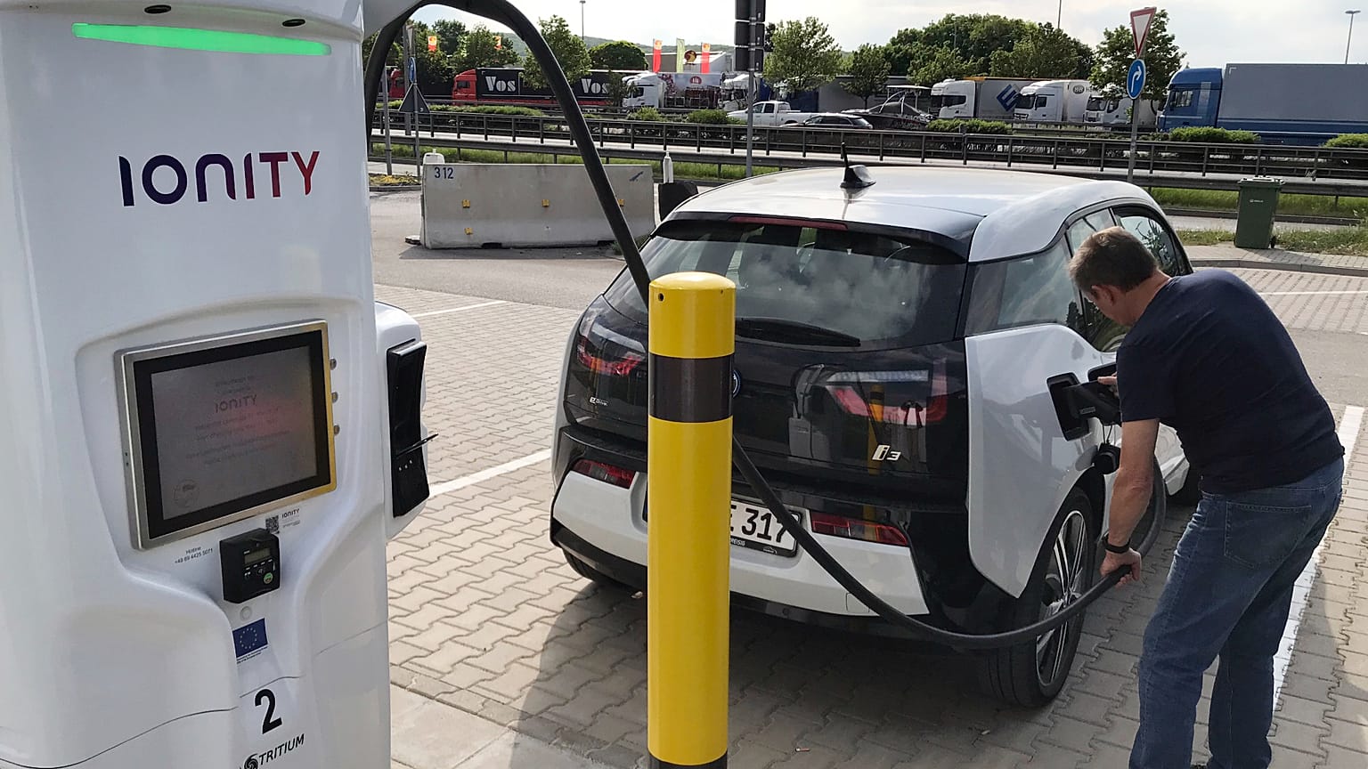 A man charges his BMW electric vehicle at the rest stop Brohltal Ost at the A61 motorway in Niederzissen, Germany, May 11, 2018.